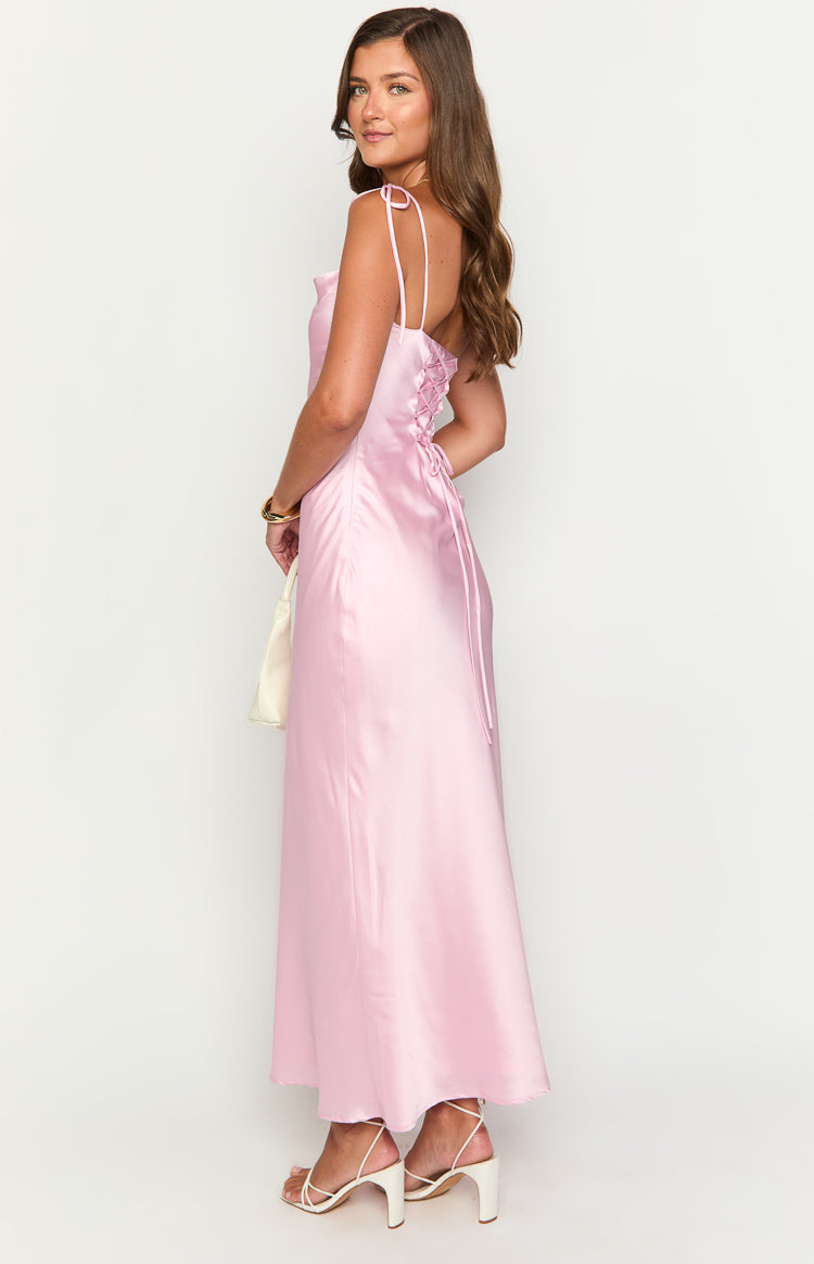 Side view of a pink satin maxi dress showing the lace-up corset back and tie shoulder straps