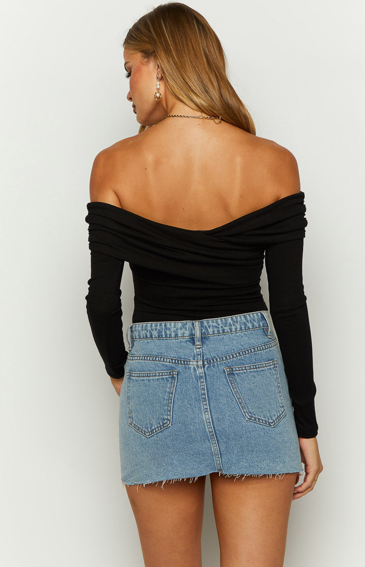 Close-up of the black ribbed off-shoulder bodysuit showing the twisted bust detail and long sleeve