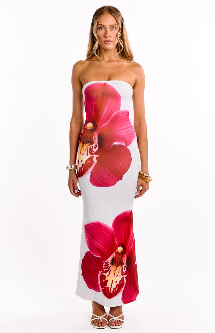 Full front view of a white strapless maxi dress with large pink orchid prints on the torso and near the hem