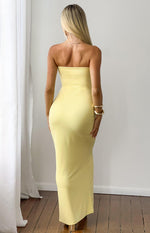 Rear view of a yellow strapless bandeau crepe maxi dress with a fitted silhouette