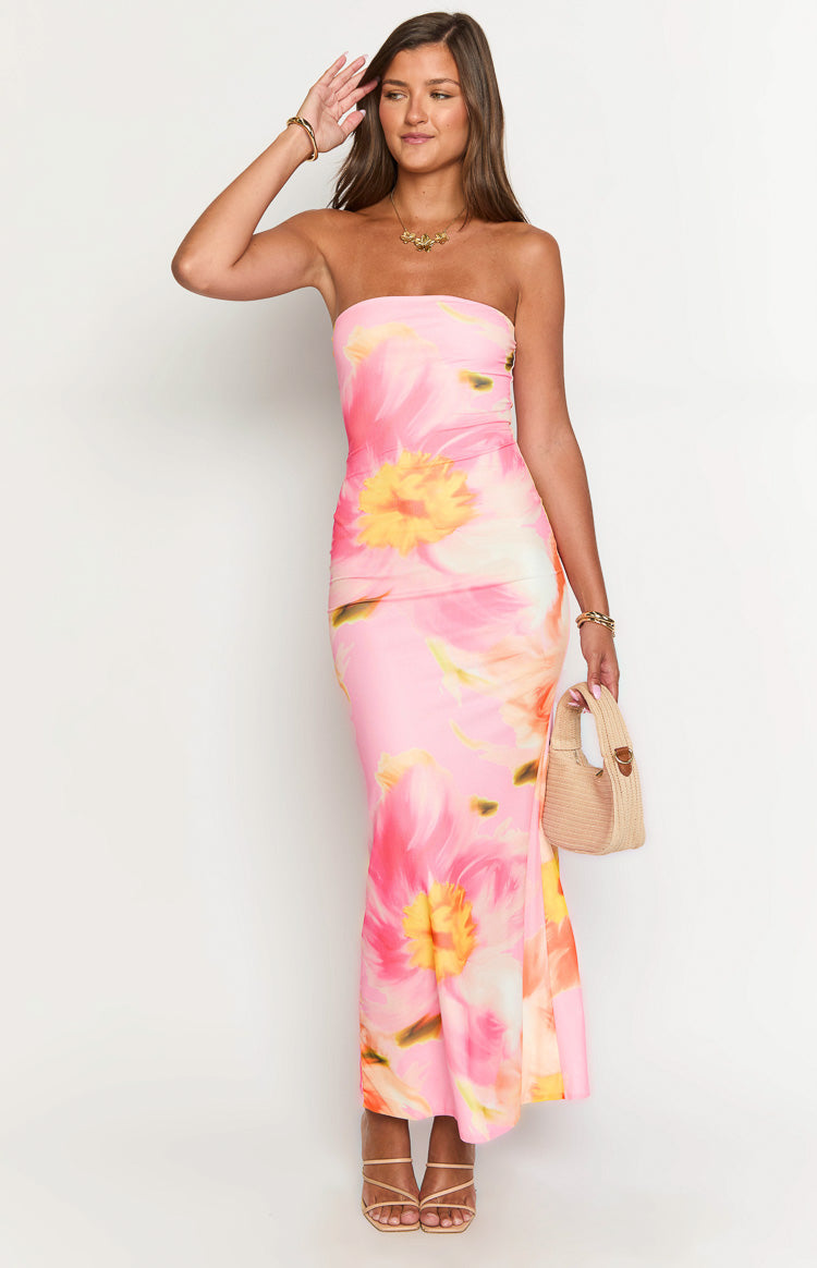 Front view of a pink and orange floral mesh maxi dress with a strapless neckline and ruched side