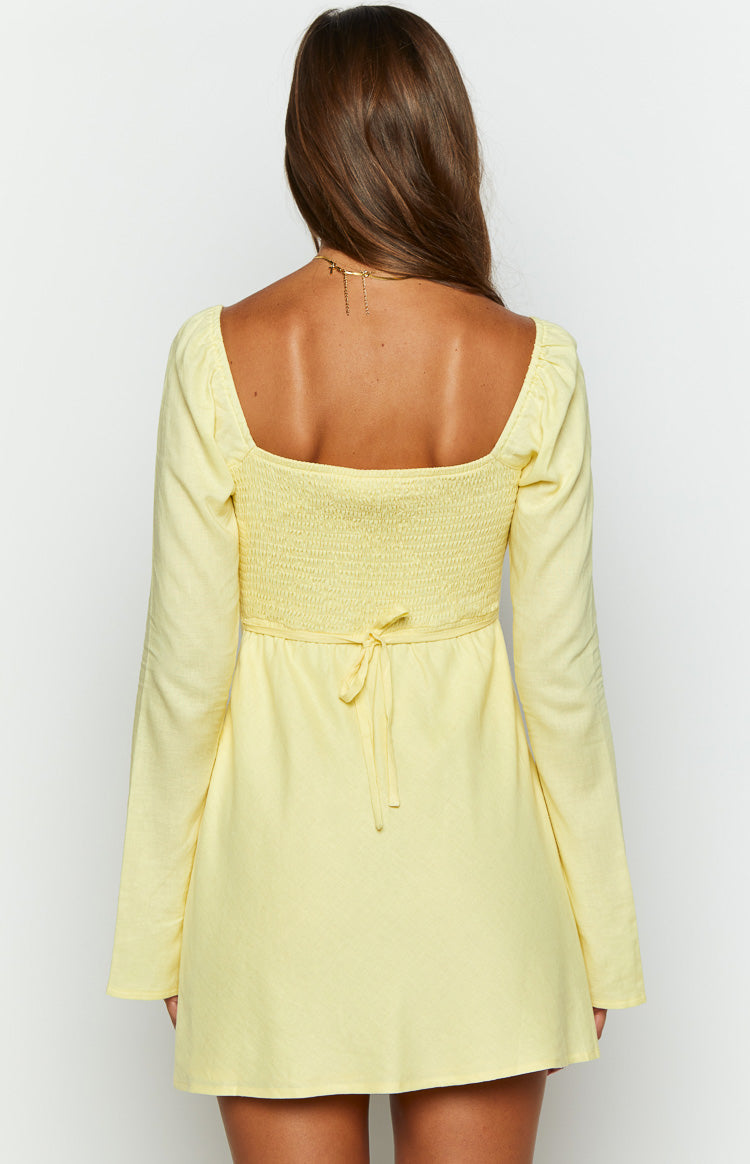 Close-up of the yellow square neckline with gathered shoulder detail and textured long sleeve