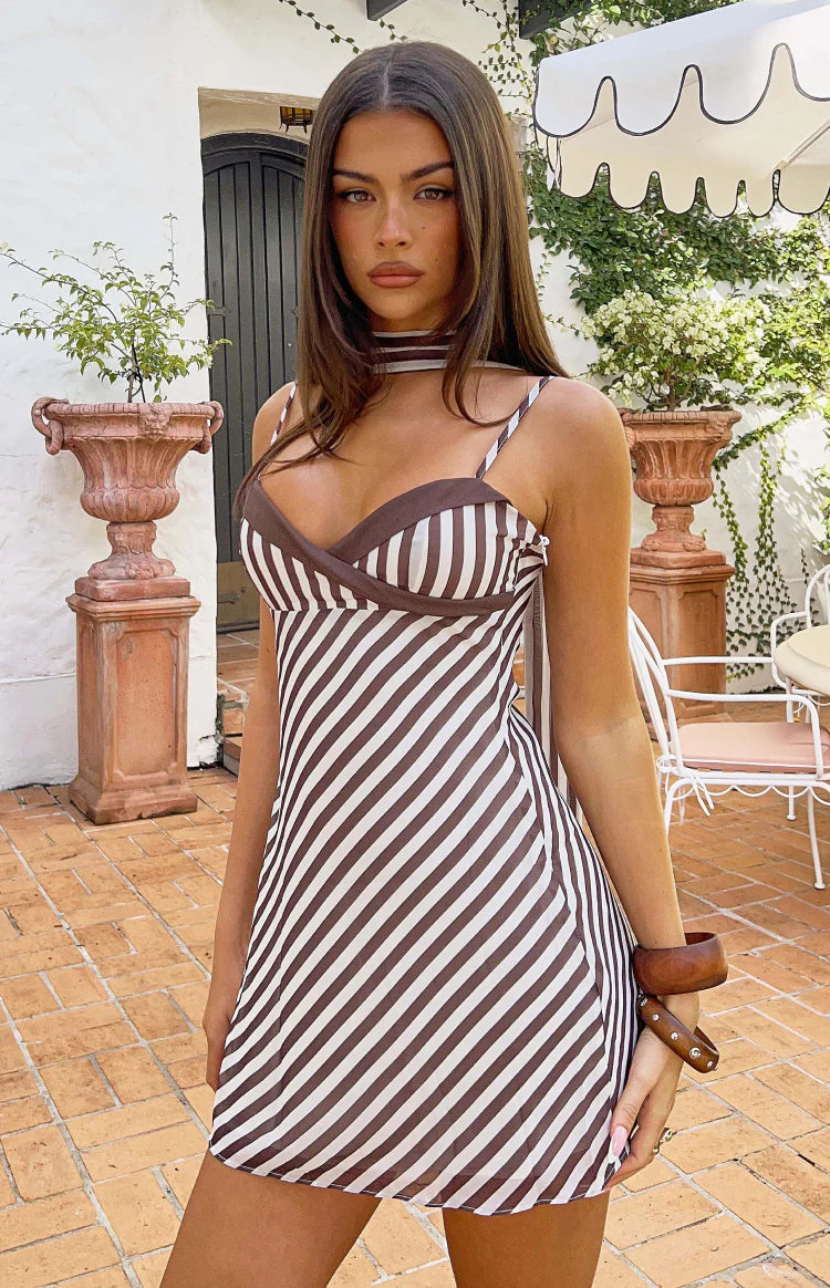 Sweetheart neckline of a brown and white diagonal stripe micro mini dress with thin straps and scarf
