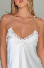 Close-up of the cream satin V-neckline with delicate lace trim and thin spaghetti straps