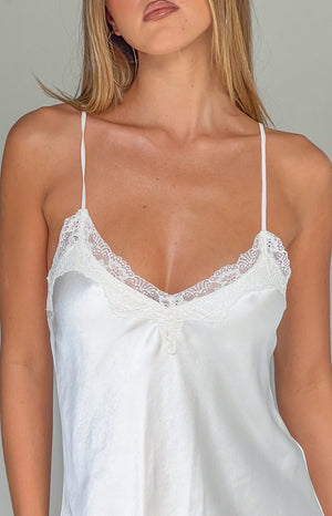 Close-up of the cream satin V-neckline with delicate lace trim and thin spaghetti straps