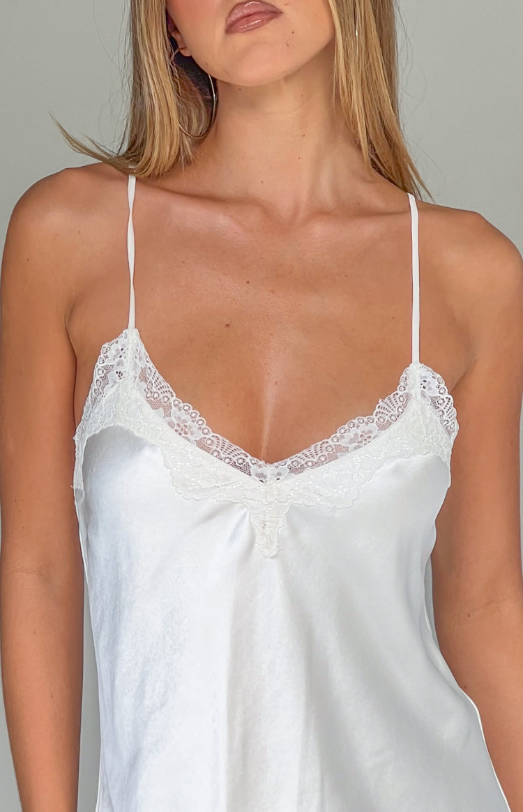 Close-up of the cream satin V-neckline with delicate lace trim and thin spaghetti straps