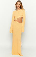 Front view of a yellow long sleeve knit maxi dress with a round neck, waist cutouts, and wide cuffs