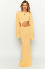 Yellow knit maxi dress with long sleeves and prominent side cutouts at the waist