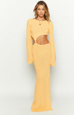 Yellow knit maxi dress with long sleeves and prominent side cutouts at the waist