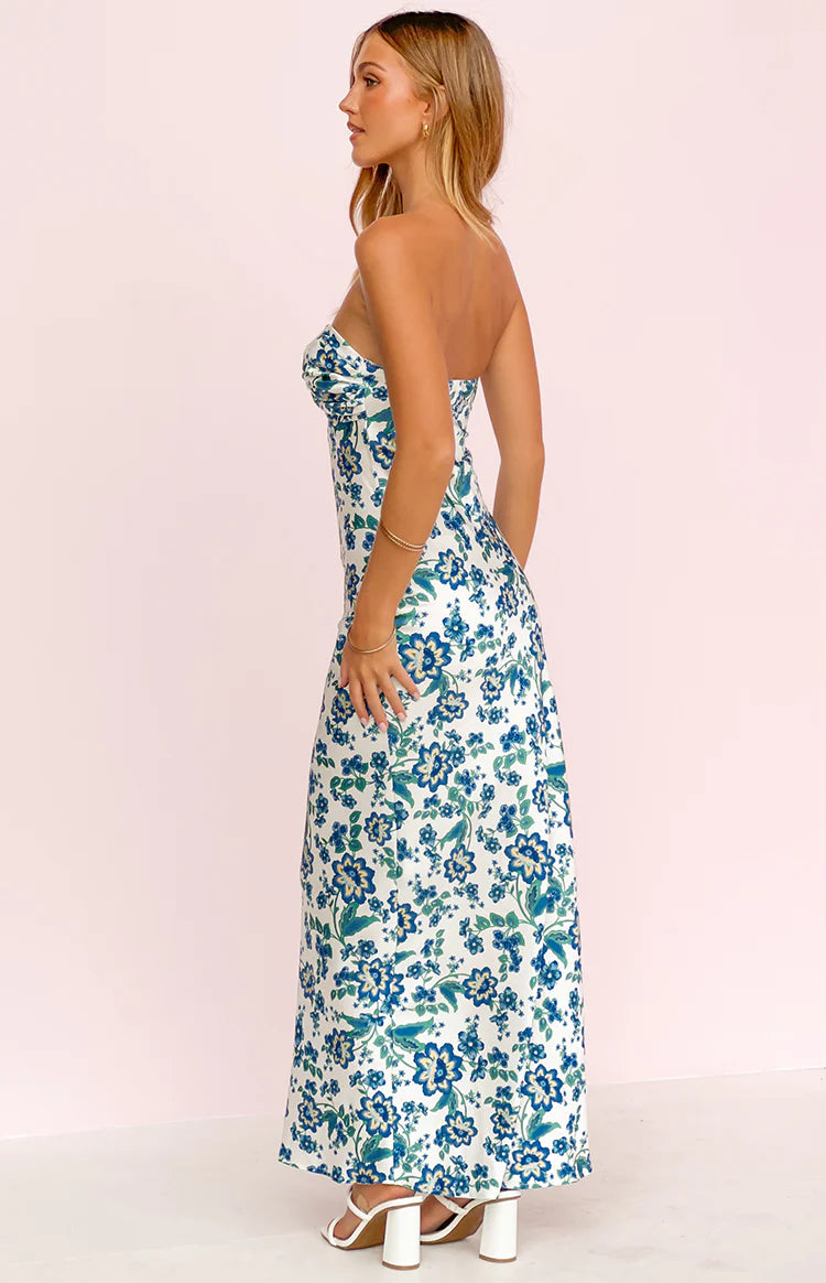 Side view of the white floral maxi dress with a strapless sweetheart neckline and flowing skirt