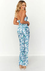 Side view of the white maxi dress with blue floral print, featuring a strapless neckline and a fitted silhouette