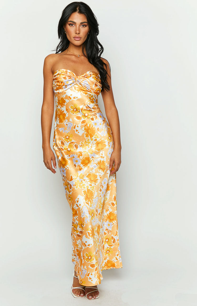 Orange floral satin maxi dress with a twisted sweetheart neckline and flowing skirt