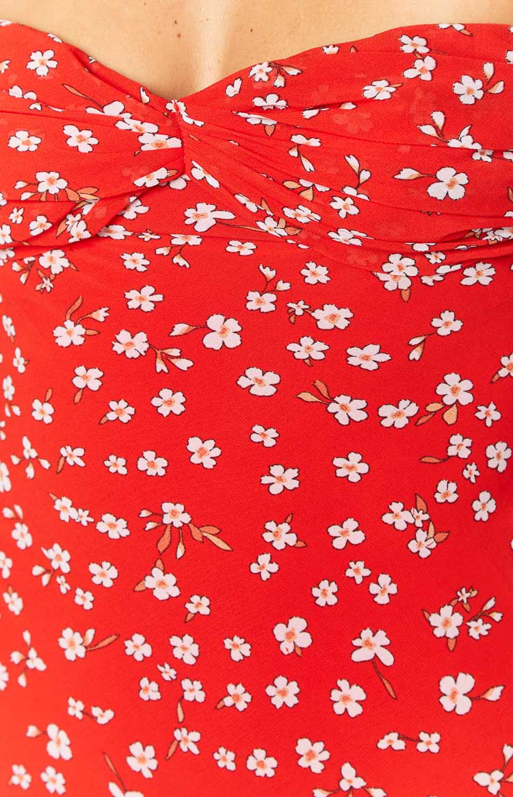 Back view of a red floral strapless maxi dress with a fitted bodice and a long flowing skirt