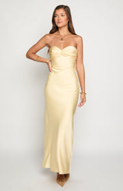 Pale yellow strapless maxi dress with a ruched sweetheart neckline and a smooth, flowing skirt