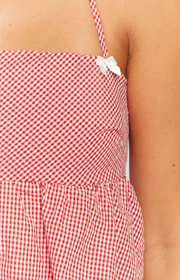 Red gingham halter top with a gathered peplum hem and small white bows on the bust