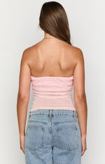 Rear view of a pink strapless top with horizontal ruffles across the back bust and a sheer body