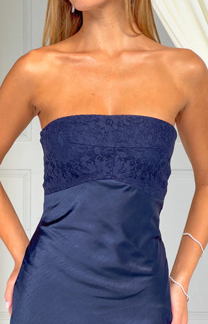 Close-up of the navy lace strapless bodice with a defined seam to the smooth satin midi skirt