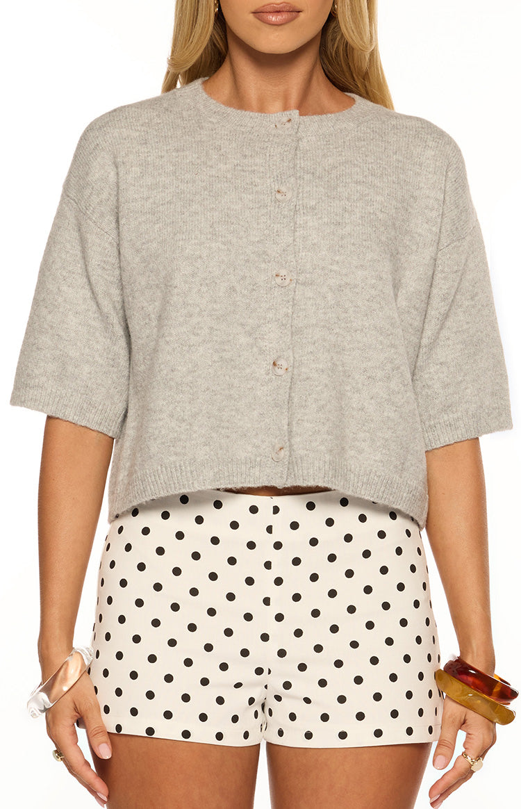 Front view of a light grey short sleeve cropped cardigan with a round neckline, button-front closure, and ribbed hem