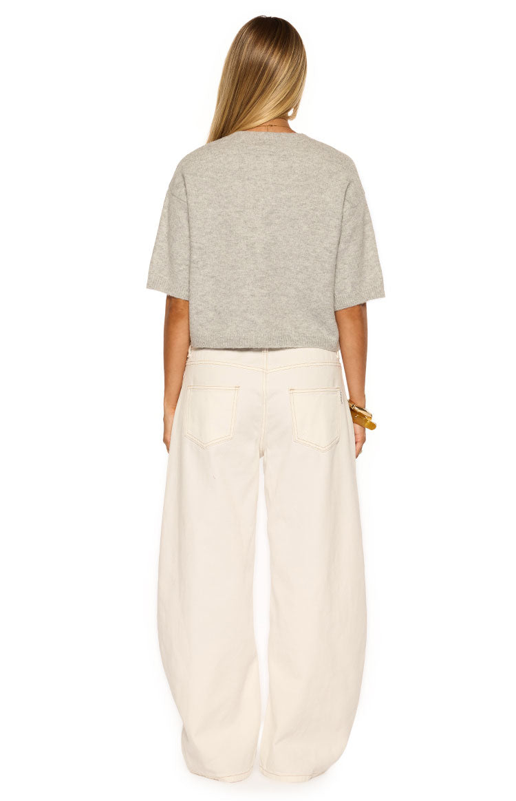 Rear view of the light grey short sleeve cropped cardigan with a crew neckline and ribbed hem