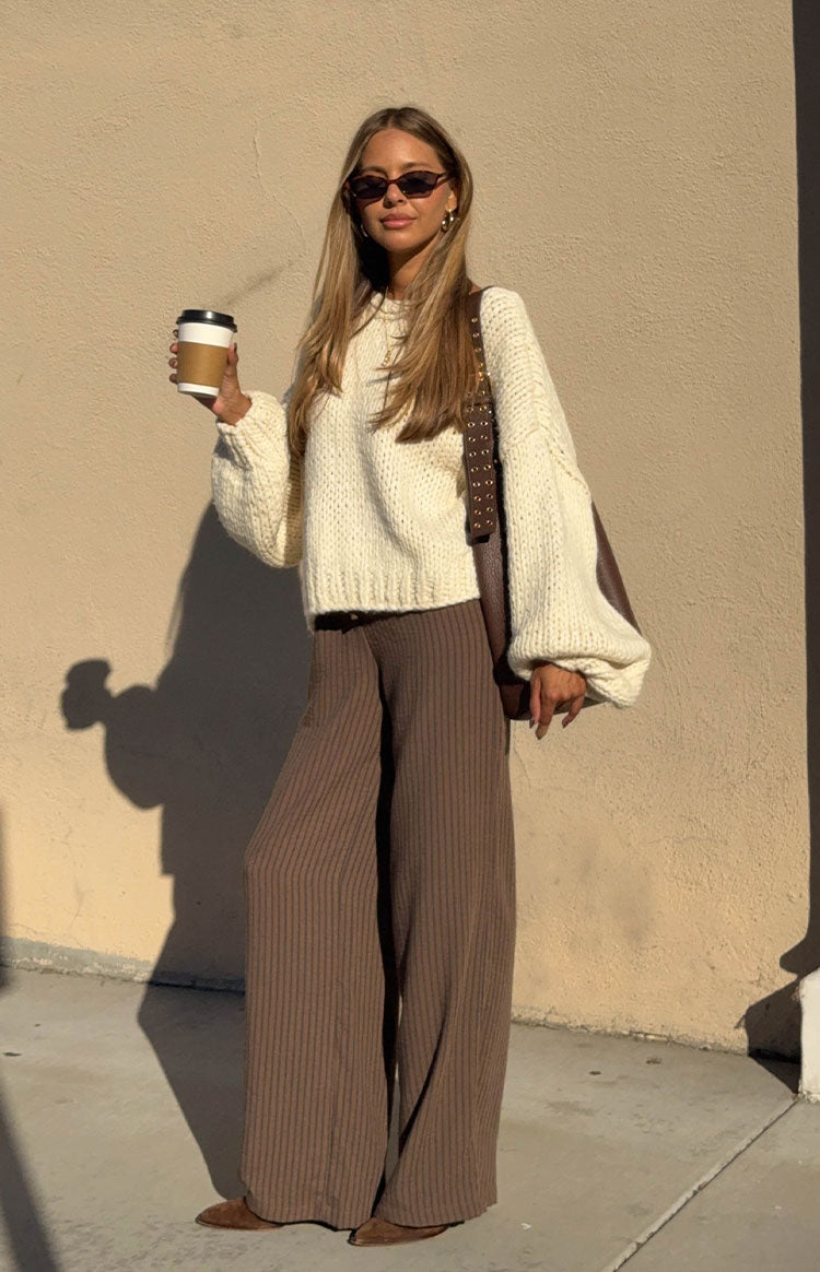 Full length view of brown wide-leg pants with subtle vertical stripes and a ribbed texture