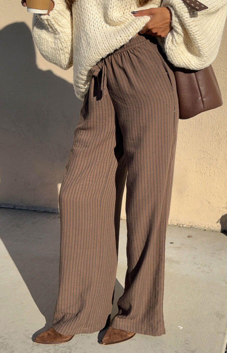 Beginning Boutique Avandi Brown Stripe Drawstring Waistband Pants brown vertical stripe wide-leg pants with a drawstring waist and crinkled texture