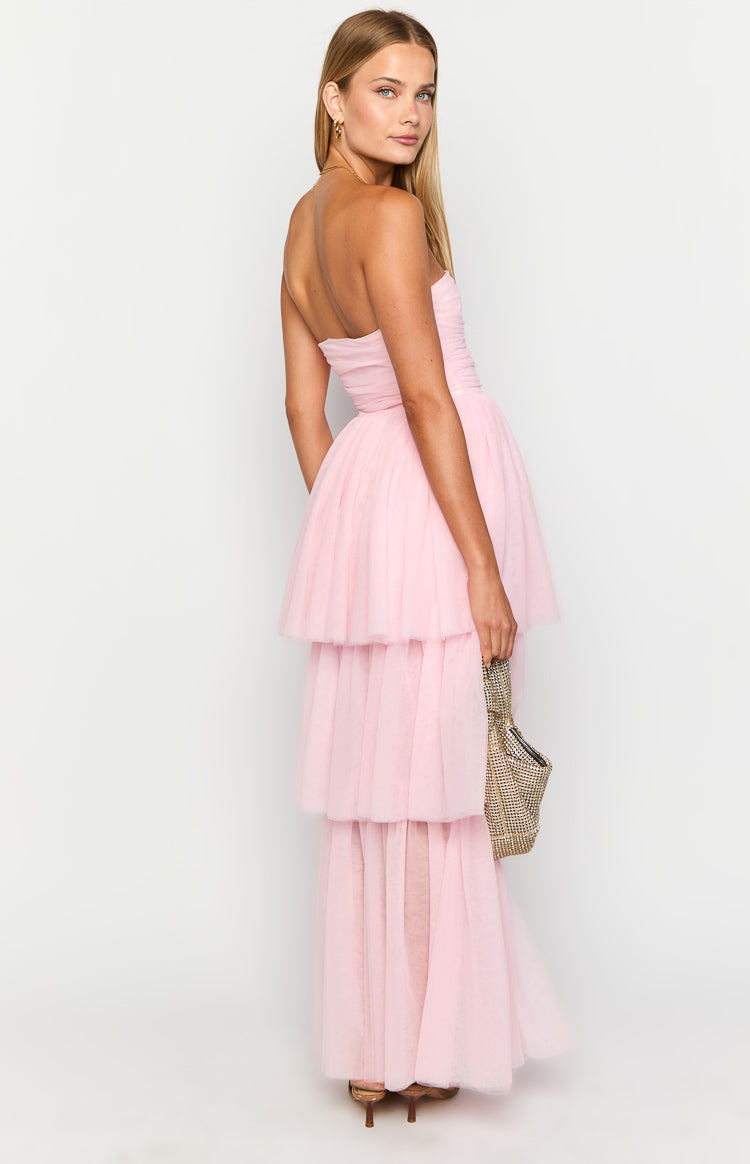 Side view of a pink strapless maxi dress with a ruched bodice and tiered high-low tulle skirt