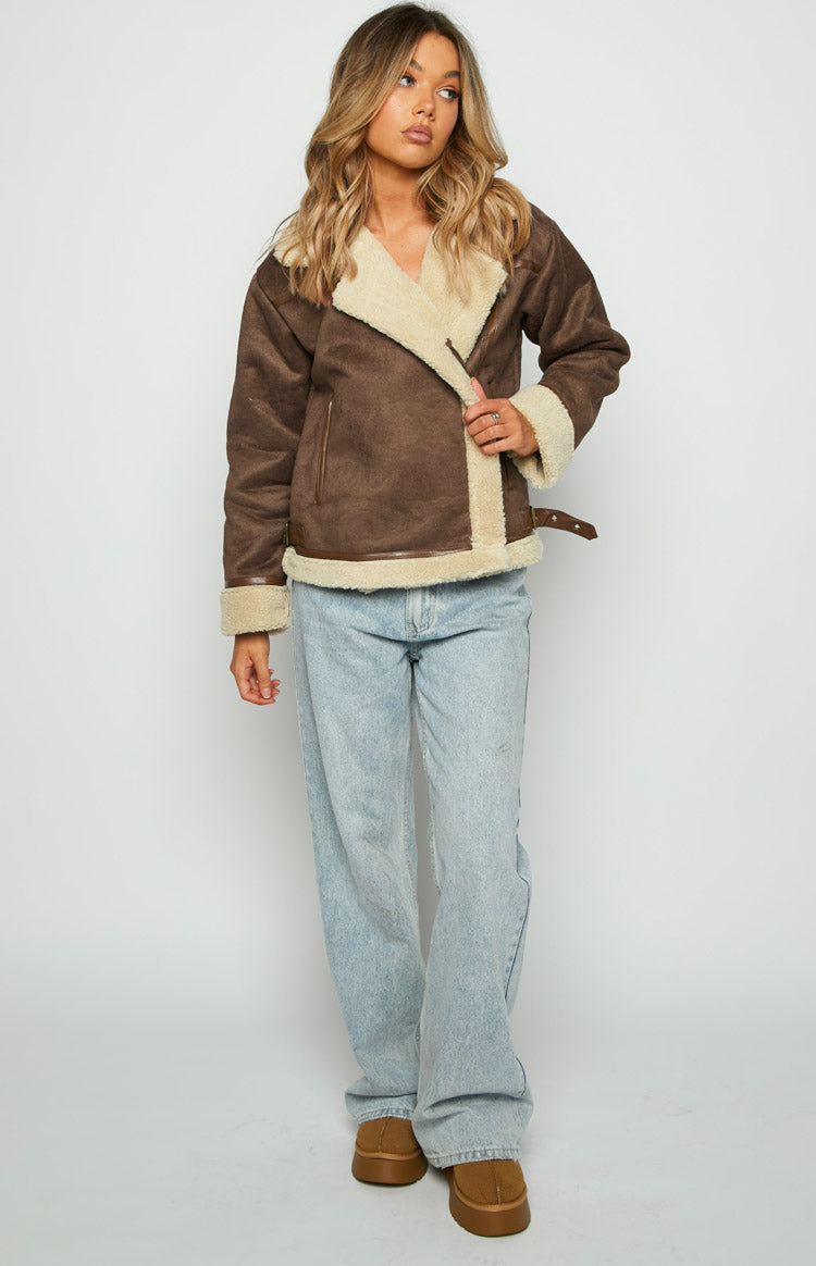 Front view of a brown faux suede aviator jacket with cream sherpa lining, wide collar, and asymmetrical zip