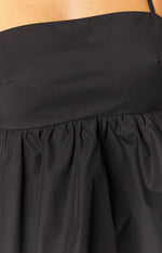 Close-up of the ruched detail on the black halter top
