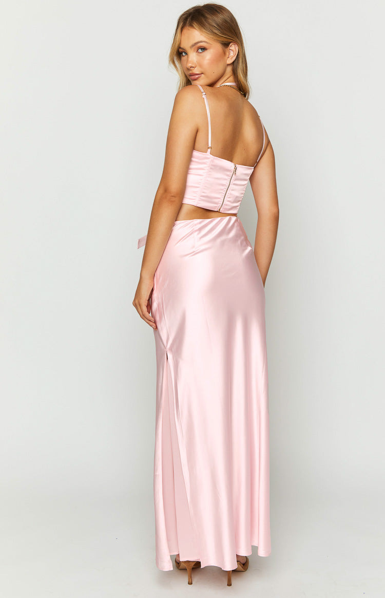 Rear view of a pink satin maxi skirt showing the side bow detail and high leg slit