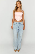 Front view of a pink satin corset top with a square neckline, thin straps, and a pointed V-hem