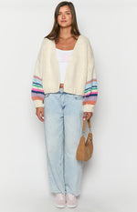 Front view of a cream chunky knit cardigan with dropped shoulders and wide sleeves featuring horizontal multi-coloured stripes