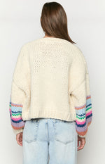 Rear view of a cream chunky knit cardigan with multi-coloured striped balloon sleeves