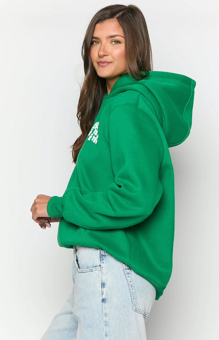 Side view of a bright green oversized hoodie with a structured hood and white chest graphic