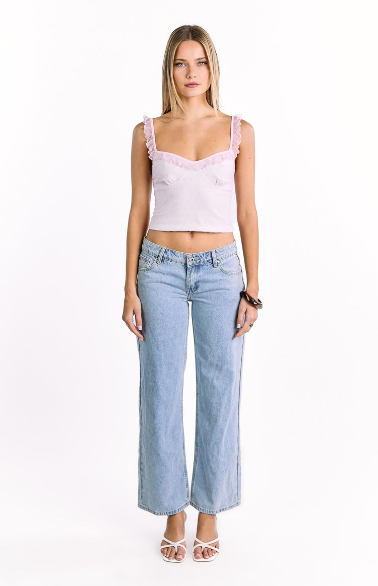 Front view of a pink and white polka dot frill top with a sweetheart neckline and frilled straps