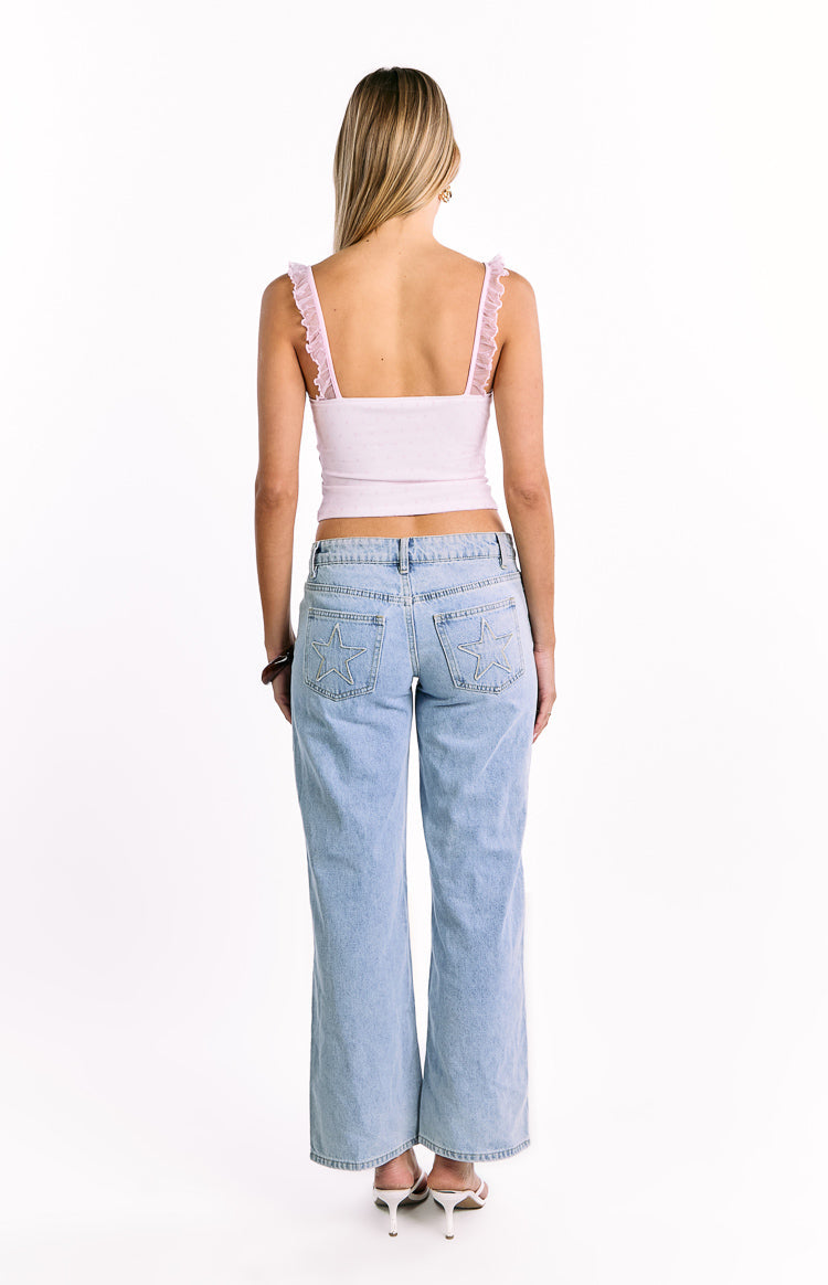 Rear view of a light pink polka dot crop top with delicate frill straps and a straight back neckline