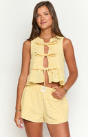 Beginning Boutique Baxter Yellow Gingham Top yellow gingham sleeveless tie-front crop top with cutouts and peplum hem