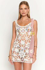 White crochet mini dress with intricate floral open-knit pattern and sleeveless design