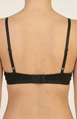 Rear view of a black jersey bralette with adjustable spaghetti straps and a triple hook-and-eye closure