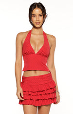Front view of a red chiffon halter neck top with a deep V-neck and gathered bust detail, featuring small black polka dots