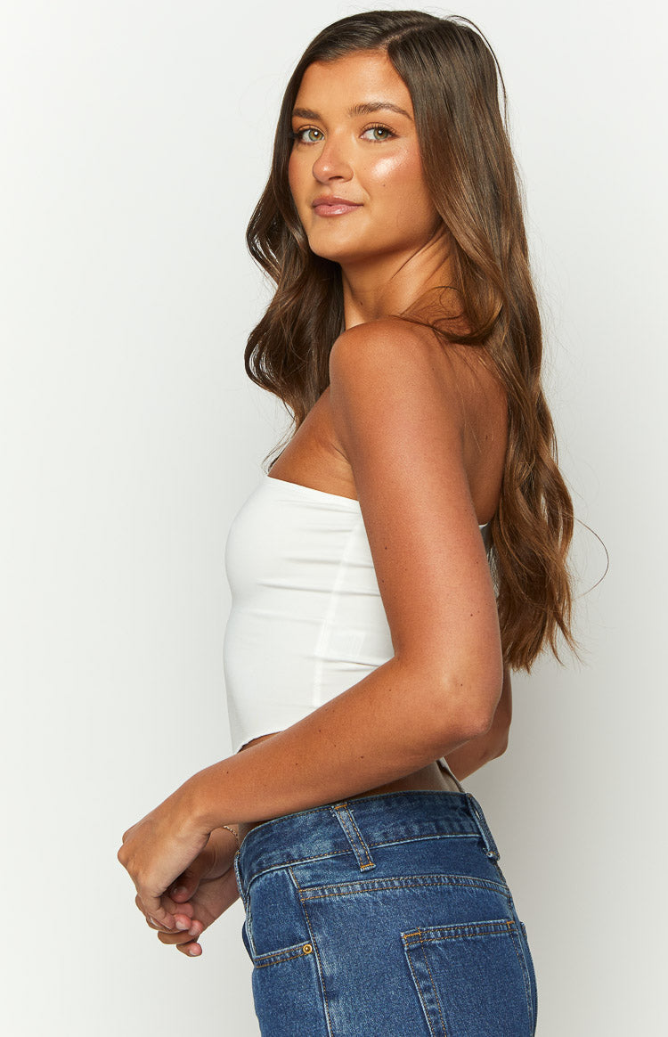 Side view of a white one-shoulder crop top with a smooth, fitted silhouette