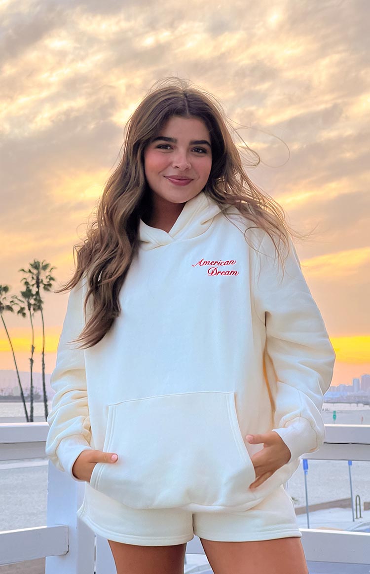 Cream hoodie with red 'American Dream' embroidery and a large front kangaroo pocket