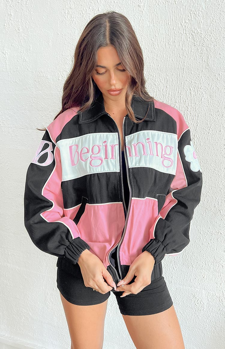 Front view of a black, pink, and white colour block bomber jacket with a collared neckline, full zipper, and embroidered "Beginning" text