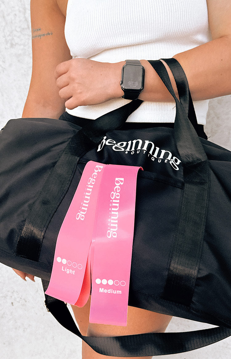 Two pink resistance bands, one labeled 'Light' and the other 'Medium', showing strength indicators