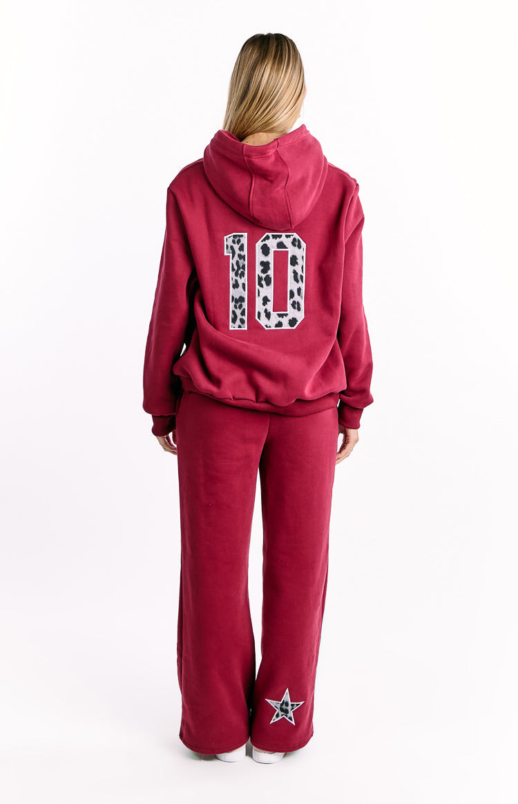 Back view of a burgundy hoodie with a leopard print '10' on the back, and matching pants with a leopard star