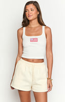 Model wearing cream coloured sweat shorts with a red embroidered American dream graphic across the back