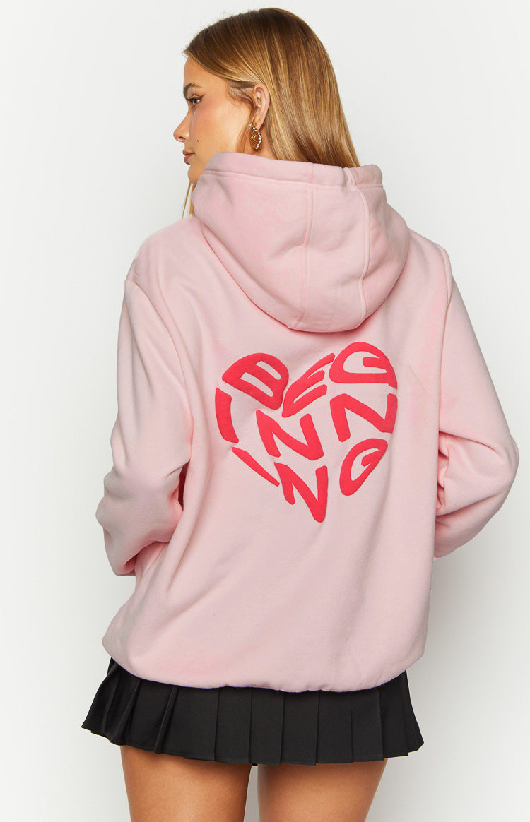 Rear view of a pink bubble hoodie with a large red heart graphic on the back, spelling 'BEGINNING'
