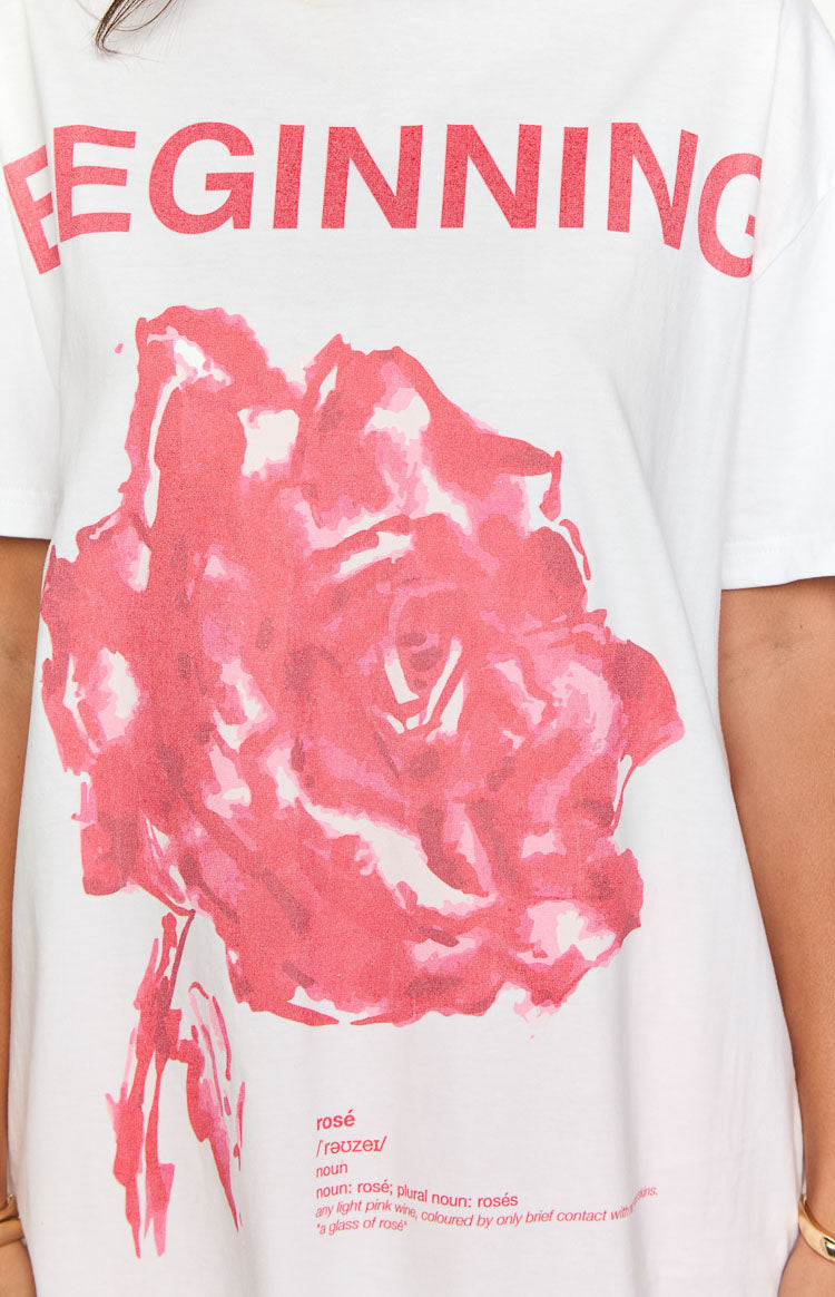 Close-up of the red 'BEGINNING' text, pink rose graphic, and rosé definition on a white tee