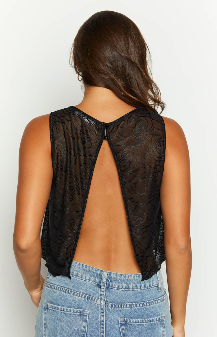 Front view of the sheer black mesh top with an embossed rose pattern and high round neckline