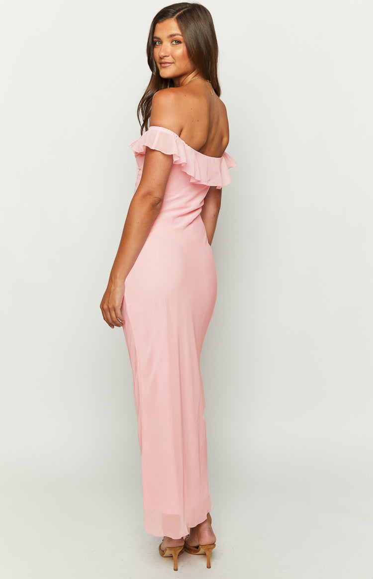 Side view of a pink chiffon maxi dress showing the off-shoulder ruffled neckline and flowy skirt