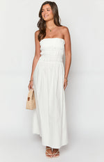White strapless maxi dress with a shirred bodice and smocked waist flowing into a relaxed A-line skirt